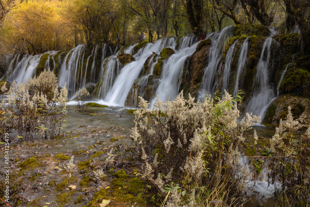 Fototapeta premium The Arrow Bamboo Lake Waterfall in Jiuzhaigou National Park is a famous tourist attraction in Sichuan, especially during the autumn leaves season, China
