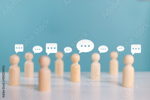 Wooden human figures with speech bubble of message and chatting. Social media interaction and chat concept