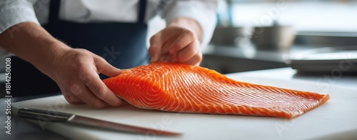 The Salmon Fillet on a Cutting Board with Chef's Hands Preparing Fresh Seafood