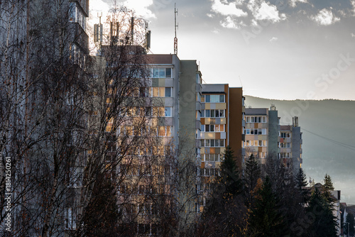 Row of insulated old tower apartment buildings at sunset in Romania.