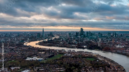 Fast moving time lapse view of the London skyline during a autumn sunset with river Thames and city skyscrapers under changing cloudscape