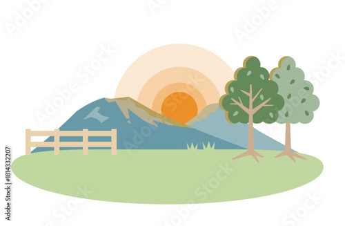 山々が見える牧草地の日の出(日没)の景色