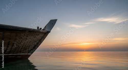 A minimalist composition of a traditional wooden dhow boat's weathered hull against a flat, calm sea at dawn. Evokes tranquility, travel, and Arabian Gulf heritage.