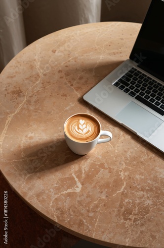 Coffee Cup and Laptop on a Marble Table in a Cozy Workspace Setting