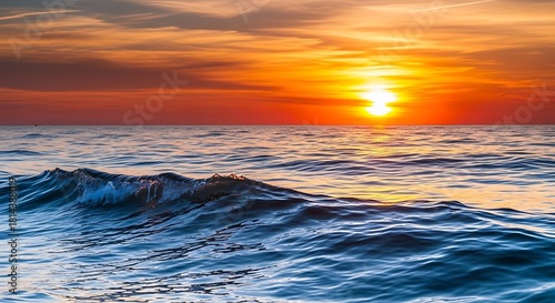 Fototapeta Naklejka Na Ścianę i Meble -  Ocean wave at sunset with vibrant sky and warm light.