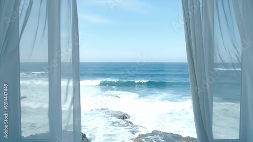 Ocean View Through Window with White Curtains and Crashing Waves on Rocky Shore