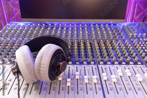 headphone on audio mixing console in studio. broadcasting, recording, music production concept