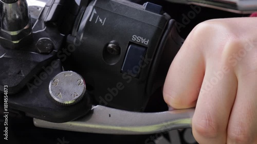Close-up of a hand gripping and pressing the motorcycle throttle handle, showcasing control, power and motorbike riding concept. Motorcycle rider squeezing the engine throttle handle