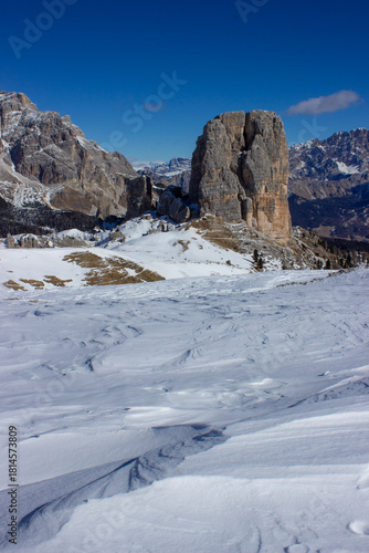 Wallpaper Mural Vertical image of Cinque Torri in the Dolomites. Wind-sculpted snow and towering rocks under a clear sky form a dramatic alpine scene, ideal for editorial and travel use. Torontodigital.ca