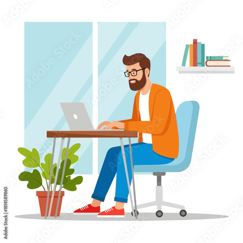 Man with beard wearing glasses and orange sweater sitting at desk working on laptop with blue chair and green plant