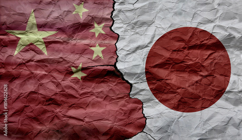 Chinese and Japanese flags on a cracked background. Political and economic conflict between China and Japan. Diplomatic conflict.