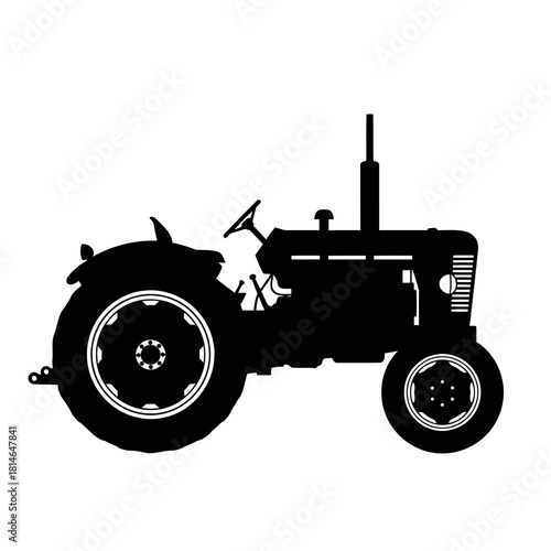 Black and white silhouette of an oldfashioned tractor with a person sitting on it, isolated on