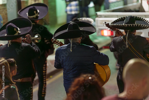 Day of the Dead Mexican Mariachi Musicians Seen from Behind in Night Street Parade