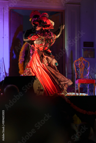 Romantic Day of the Dead Catrin and Catrina Embracing While Dancing on Night Stage