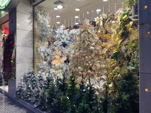 Festive christmas window display with ornate decorations and glittering trees