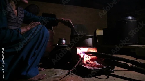 A close-up shot of an Indian village woman boiling fresh cow’s milk on a traditional government-provided chulha stove, capturing rural lifestyle, daily chores, and authentic Uttarakhand household life