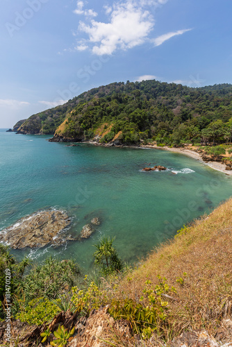 Scenic view of the sea, rocky shoreline and lush nature from above at the Mu Ko Lanta National Park in Koh Lanta, Thailand, on a sunny day.