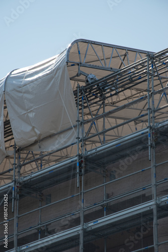 Scaffolding on the roof of a construction site to protect workers from the sun's rays and heat, Rome, Italy.