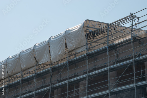 Scaffolding on the roof of a construction site to protect workers from the sun's rays and heat, Rome, Italy.
