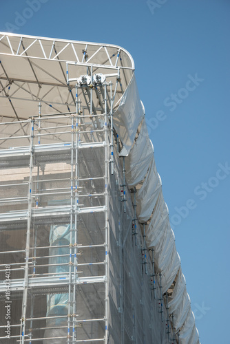 Scaffolding on the roof of a construction site to protect workers from the sun's rays and heat, Rome, Italy.
