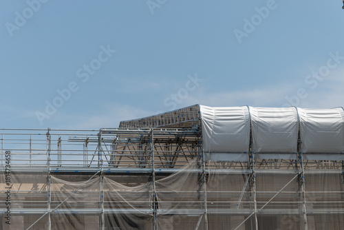 Scaffolding on the roof of a construction site to protect workers from the sun's rays and heat, Rome, Italy.