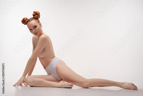 Beauty woman in a studio posing topless with stylish hair and elegance