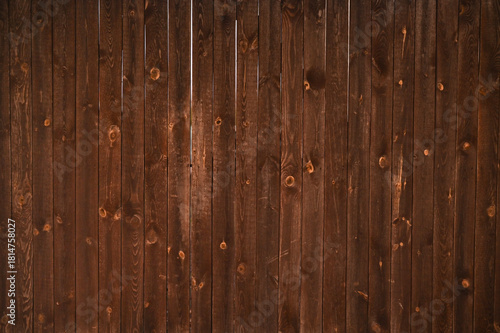 Rustic brown fence made of wooden planks with natural textured surface. abstraction background. Close-up of timber wall used as natural backdrop with rustic countryside style.