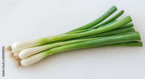 Fresh Green Onions Arranged on a White Surface Ready for Cooking or Garnishin...