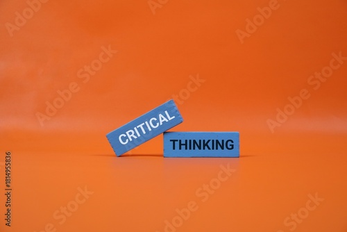 orange background highlights blue blocks with the words Critical and Thinking. Perfect for education, business, creativity, and brainstorming themes.