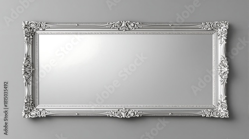 Silver mirror with classic frame on gray wall