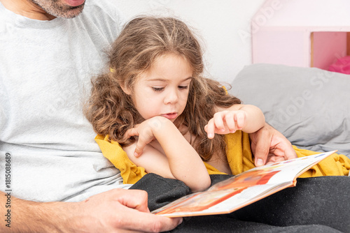 Quadro em tela Family man and girl read children book, dad tell daughter story before go to bed