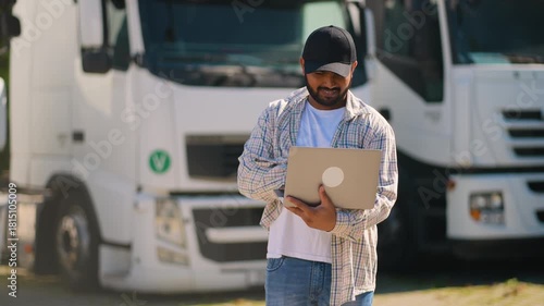 Truck driver managing fleet logistics with laptop