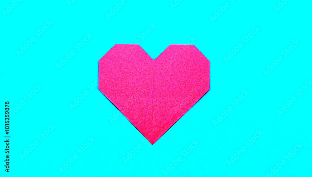 Fototapeta premium Geometric paper heart on a blue surface representing love