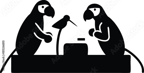 Two parrots at a table with a microphone and a small object