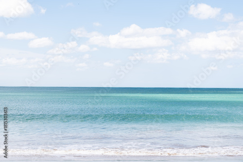 bright blue sea and blue sky with some clouds in the background