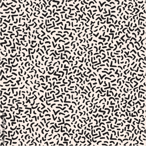 Abstract pattern of black, curved, and angular shapes scattered across a light background, creating a playful and retro aesthetic ideal for graphic design and textile applications