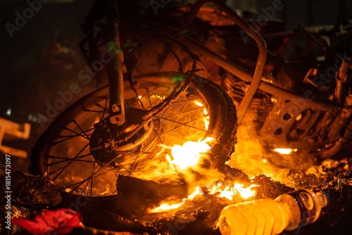 Fotografie Bike tires on fire in the night with large flames