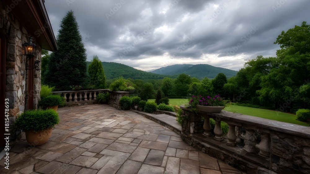 Obraz premium Elegant stone patio overlooks a lush landscape under dramatic cloudy skies