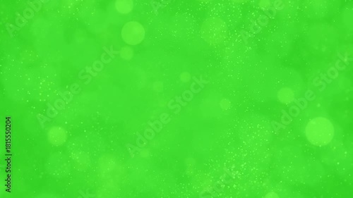 Soft Golden Bokeh Circles and Fine Particles Floating Slowly on a Green Screen Chroma Key Overlay.