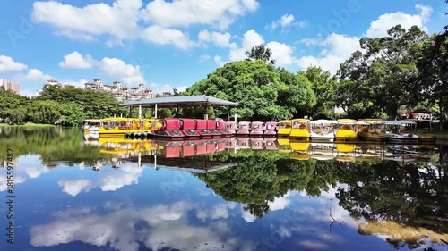A peaceful 4K lake scene featuring paddle boats gliding on calm water. Ideal for travel content, nature footage, tourism promos, and relaxing background visuals.