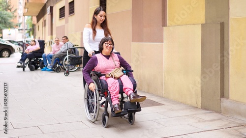 Caregiver assisting woman in wheelchair promoting inclusion and diversity