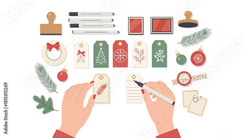 Hands writing on Christmas gift tags with various holiday craft supplies.