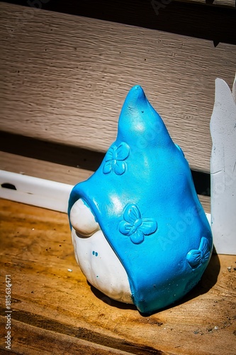 A small yard gnome on a porch