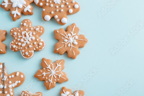 Gingerbread cookies decorated with white snowflake icing creating a festive winter holiday background with copy space