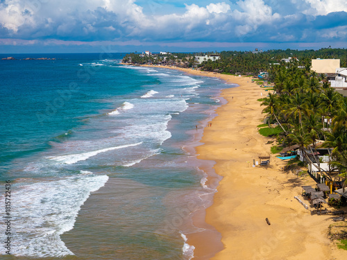 Aerial view of Hikkaduwa Beach with golden sand and turquoise waves, Sri Lanka