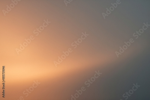 Soft evening glow in warm orange and gray tones, elegant minimal abstract gradient background for luxury and lifestyle design
