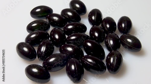 Black capsules in the form of tablets