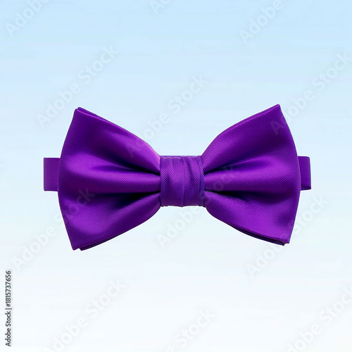 A silk purple bow tie, an elegant accessory and decoration, isolated on a white background for a fashion or celebration image