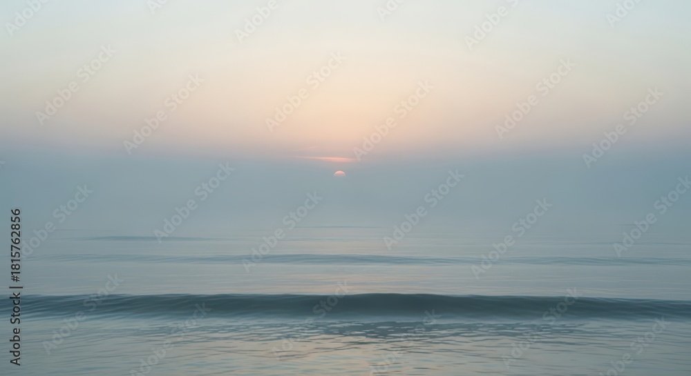 Fototapeta premium Soft pastel sunrise over a calm ocean with gentle wave motion blur