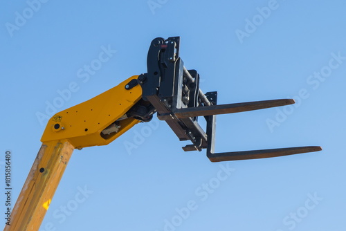 Canvas Print Forklift loader or stacker on blue sky background